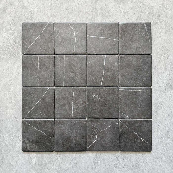 Product image of Giovanni Square Nero Vintage Marble wall and floor tiles in an 11cm x 11cm format, featuring a dark charcoal marble effect surface with subtle white veining and rounded vintage-inspired edges.