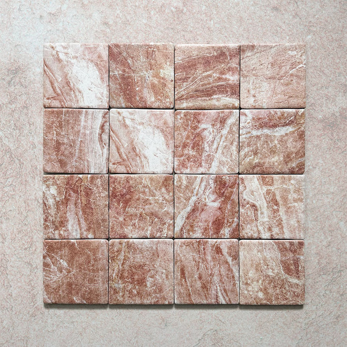 Product image of Giovanni Square Rouge Vintage Marble wall and floor tiles in an 11cm x 11cm format, featuring warm blush pink marble effect detailing, natural veining and rounded vintage-inspired edges.