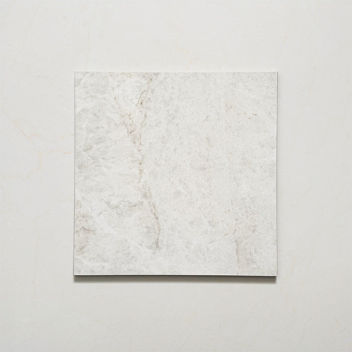 Close-up of Grand Bazaar Mahal matt marble-effect tile in a 30cm x 30cm format, featuring soft white and light grey tones with subtle natural stone-inspired movement and delicate veining. The understated marble effect creates a timeless, elegant finish, making it ideal for chequerboard floor designs, bathrooms, hallways and classic interior schemes.