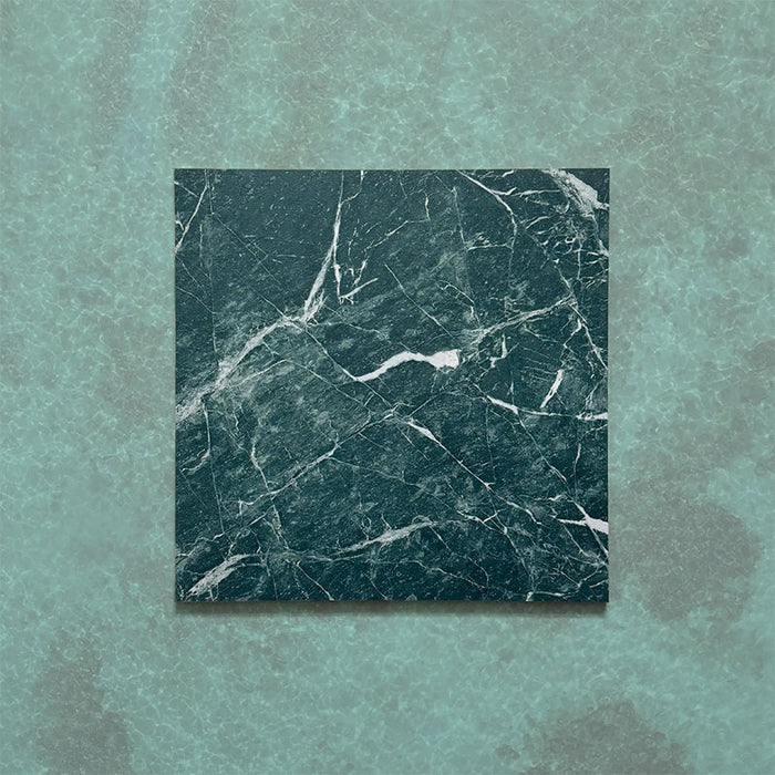 Close-up of Grand Bazaar Verde Green matt marble-effect tile in a 30cm x 30cm format, featuring deep green tones with striking white marble-inspired veining and natural stone-effect variation. The rich colour and dramatic pattern create a bold, luxurious finish, ideal for statement chequerboard floors, feature areas and characterful interior spaces.