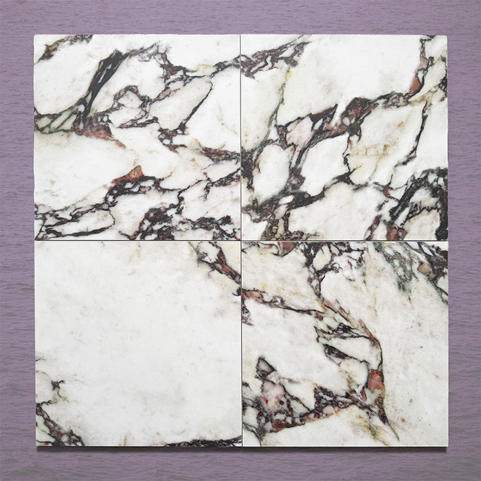 Close-up of Grand Bazaar Violetta matt marble-effect tile in a 30cm x 30cm format, featuring a white background with dramatic burgundy, plum and charcoal veining. The bold natural marble-inspired pattern creates a luxurious statement look, ideal for chequerboard floor designs and feature spaces.
