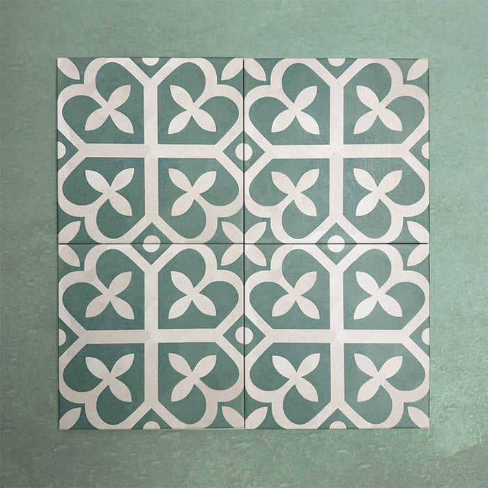 Group of Iris Green Victorian Moroccan-style 20×20cm porcelain tiles arranged together to showcase the repeating soft green and cream geometric pattern, ideal for creating decorative feature floors and walls.