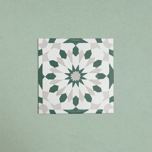Soukaina Green A 20cm x 20cm Moroccan-style patterned porcelain tile, featuring a geometric star design in soft green, off-white and warm neutral tones with a matt finish.
