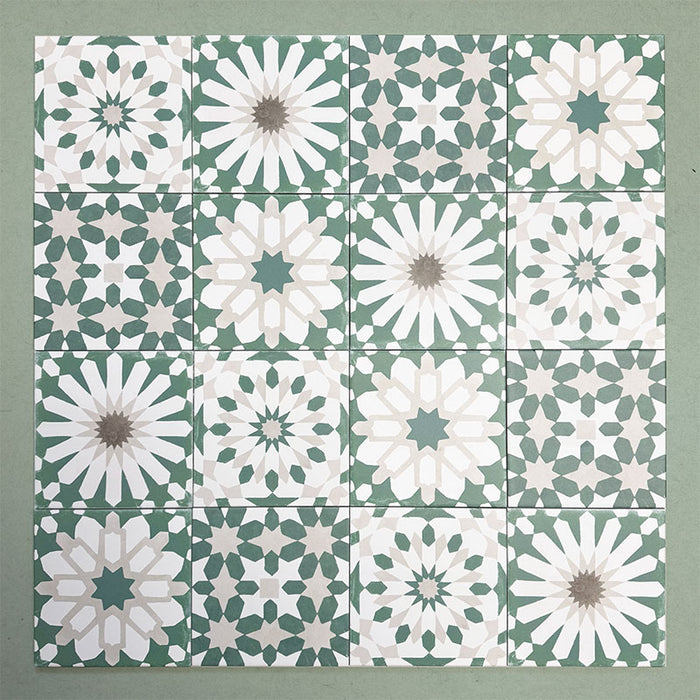 Patchwork layout of Soukaina Green C Moroccan-style 20cm x 20cm patterned porcelain tiles, combining multiple geometric designs in soft green, white and neutral tones with a matt finish.