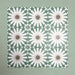 Group of Soukaina Green B Moroccan-style 20cm x 20cm patterned porcelain tiles, showing a repeating geometric star design in deep green, white and warm neutral tones with a matt finish.