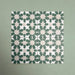 Group of Soukaina Green C Moroccan-style 20cm x 20cm patterned porcelain tiles, showing a repeating geometric star pattern in deep green and soft neutral tones with a matt finish.