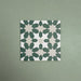 Soukaina Green C 20cm x 20cm Moroccan-style patterned porcelain tile, featuring a repeating geometric star motif in deep green and soft neutral tones with a matt finish.