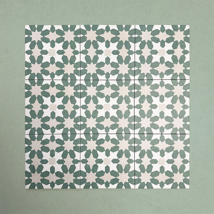 Group of Soukaina Green C Moroccan-style 20cm x 20cm patterned porcelain tiles, showing a repeating geometric star pattern in deep green and soft neutral tones with a matt finish.