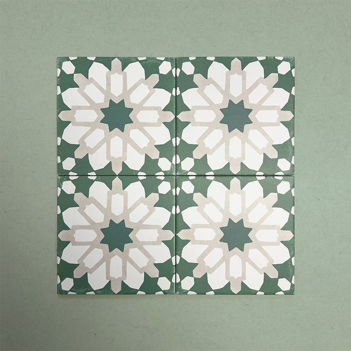 Group of Soukaina Green D Moroccan-style 20cm x 20cm patterned porcelain tiles, showing a repeating central star motif in deep green, white and soft neutral tones with a matt finish.