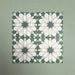 Group of Soukaina Green D Moroccan-style 20cm x 20cm patterned porcelain tiles, showing a repeating central star motif in deep green, white and soft neutral tones with a matt finish.