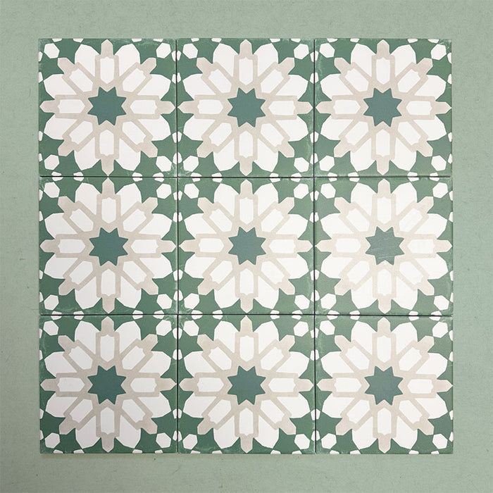 Group of Soukaina Green D Moroccan-style 20cm x 20cm patterned porcelain tiles, showing a repeating central star motif in deep green, white and soft neutral tones with a matt finish.
