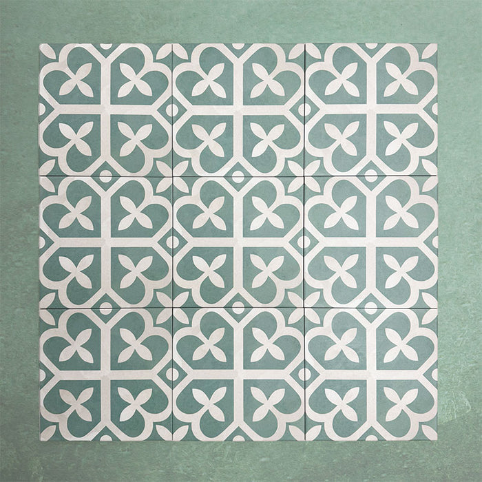 Group of Iris Green Victorian Moroccan-style 20×20cm porcelain tiles arranged together to showcase the repeating soft green and cream geometric pattern, ideal for creating decorative feature floors and walls.