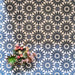 Arrangement of Fizaan Federal Blue 20x20cm Moroccan-style porcelain tiles, showcasing a repeating geometric pattern in deep blue and soft neutral tones.