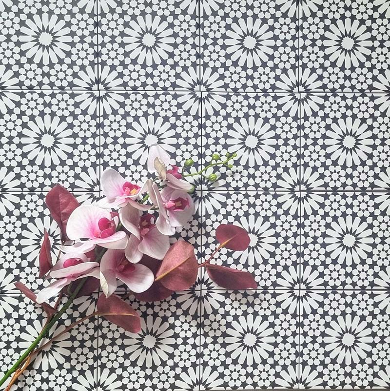 Fizaan Winter Mini Moroccan-style 15×15cm porcelain tiles laid in a repeating geometric pattern, featuring a black and white star motif.