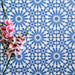 Arrangement of Fizaan Azure Blue 20x20cm Moroccan-style porcelain tiles, showcasing a repeating geometric pattern in vibrant blue and white tones.