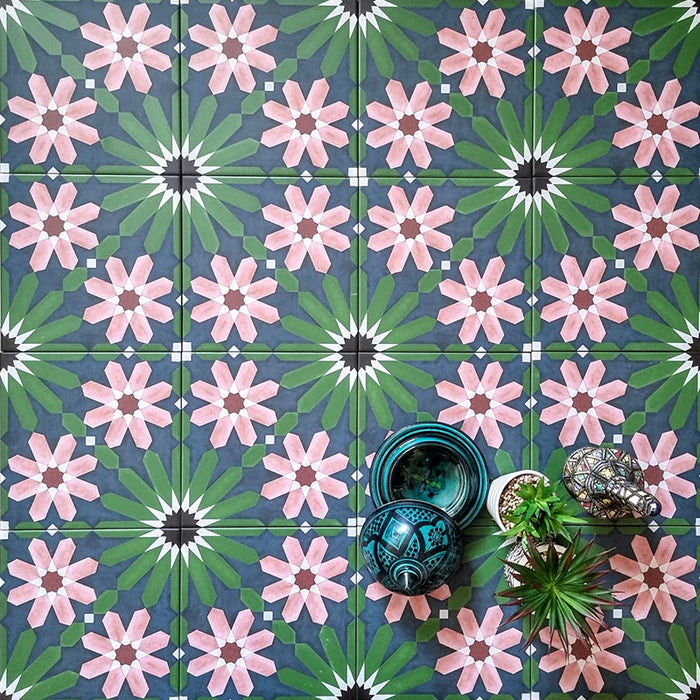 Fizaan Autumn Moroccan-style 20×20cm porcelain tiles laid in a repeating geometric pattern, featuring dark blue, green and pink floral star motifs.