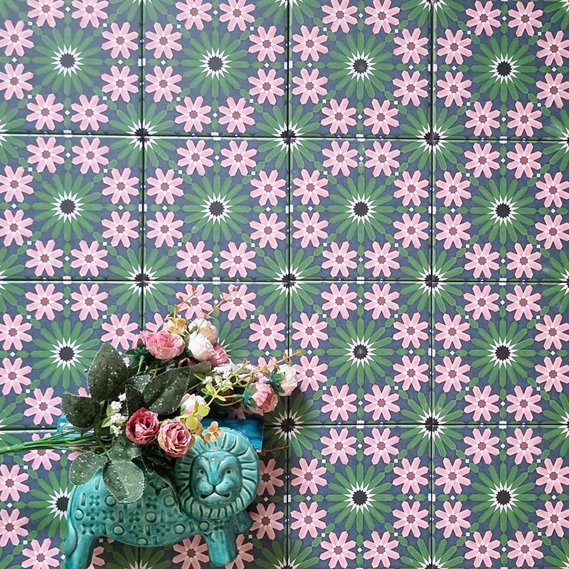 Fizaan Autumn Mini Moroccan-style 15×15cm porcelain tiles laid in a repeating geometric pattern, featuring green and pink floral star motifs.