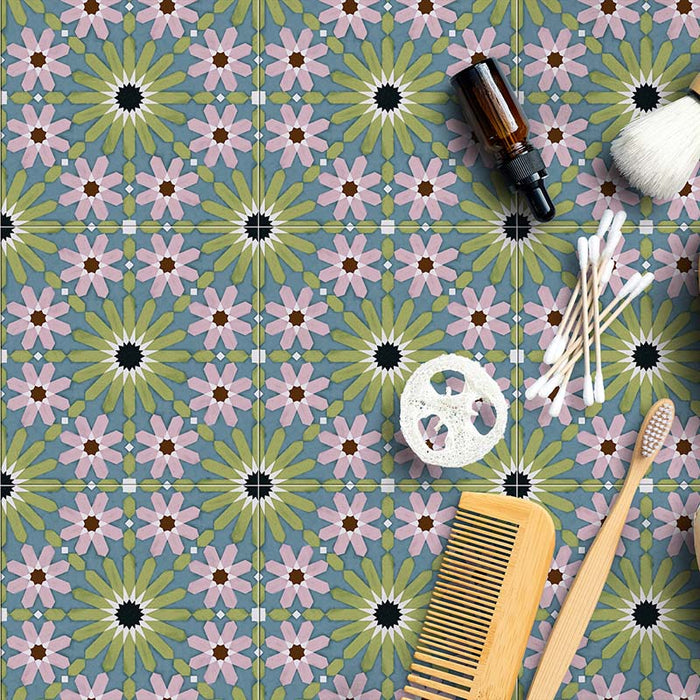 Fizaan Summer Mini Moroccan-style 15×15cm tiles laid in a repeating geometric pattern, featuring blue, green and pink floral star motifs.