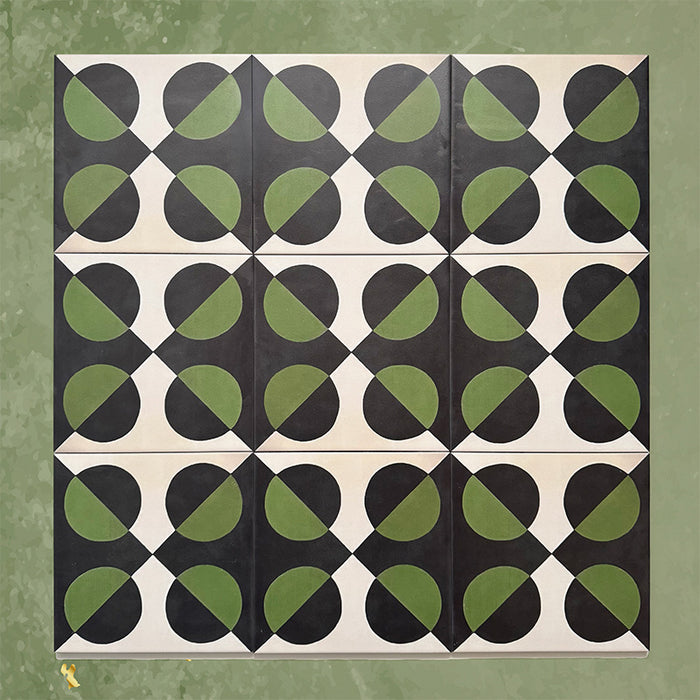 Group image showing multiple Geometry Illusion Verde Noir 20x20cm geometric patterned tiles arranged in a repeating layout, featuring green and black semicircles with cream diamond-shaped intersections, photographed against a mottled green background.