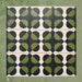 Group image showing multiple Geometry Illusion Verde Noir 20x20cm geometric patterned tiles arranged in a repeating layout, featuring green and black semicircles with cream diamond-shaped intersections, photographed against a mottled green background.