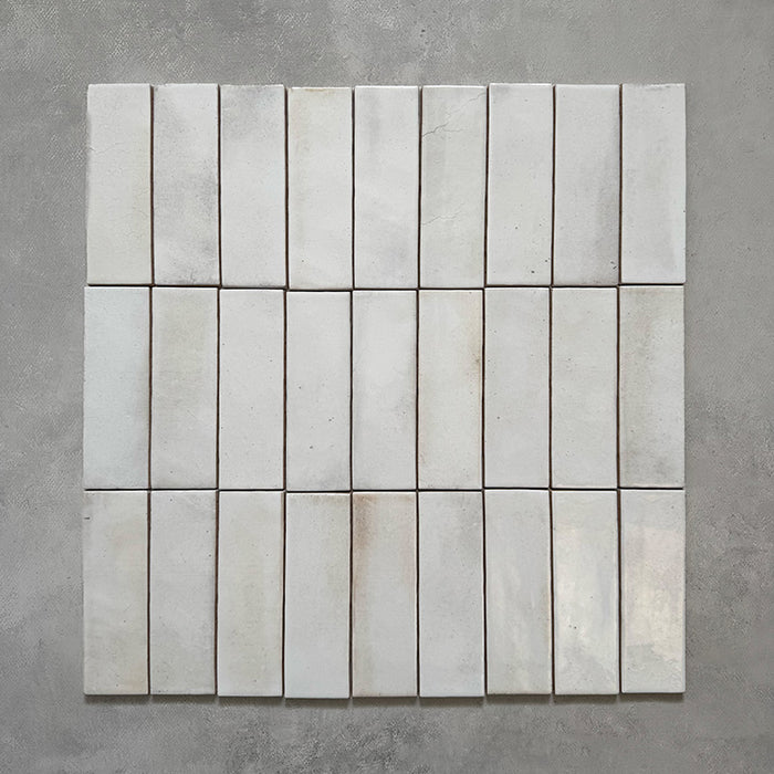 Beijing White 5.1x16.1cm Moroccan brick tiles arranged in a grid formation, showing subtle tone variation and handcrafted imperfections that create a natural, artisanal wall finish.