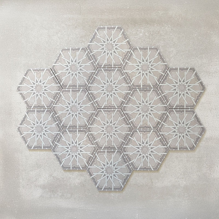 Maroush Mareshan Ice White 18.7x21.6cm Moroccan hexagonal tiles displayed in a group layout, featuring an intricate star-inspired geometric pattern in soft white and grey tones on a light textured background.