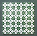 Group of Agraba Green 20x20cm Moroccan-style ceramic tiles showing a repeated geometric star pattern in rich green and white tones, displayed on a dark green background to highlight the intricate design.