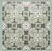 Group of Bloom Green 20x20cm Moroccan-style ceramic tiles arranged together, showcasing a repeating floral pattern in soft green, grey, and white tones on a green background.