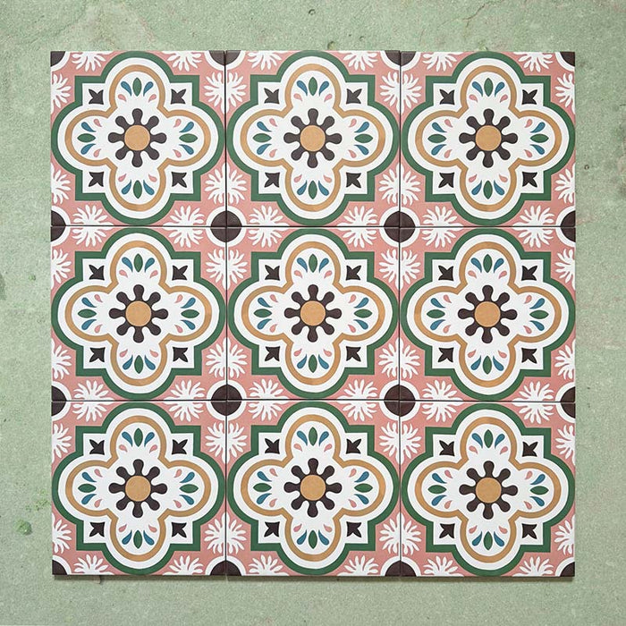 Cabana Paradise 20x20cm Moroccan-style ceramic tiles shown in a grouped layout, featuring a pink, green, and mustard floral pattern on a soft green background.