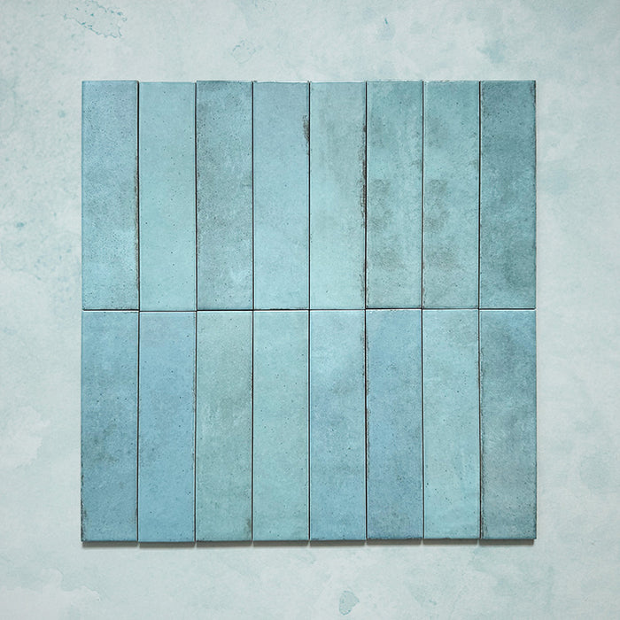 Madison Aquamarine Brick Wall Tiles 6x24.6cm — group layout showcasing the rich tonal variation and handcrafted charm of these glossy teal tiles. Their soft aquatic hues and subtle imperfections capture a timeless artisanal feel, perfect for adding depth and vibrancy to walls in kitchens, bathrooms, or feature spaces.