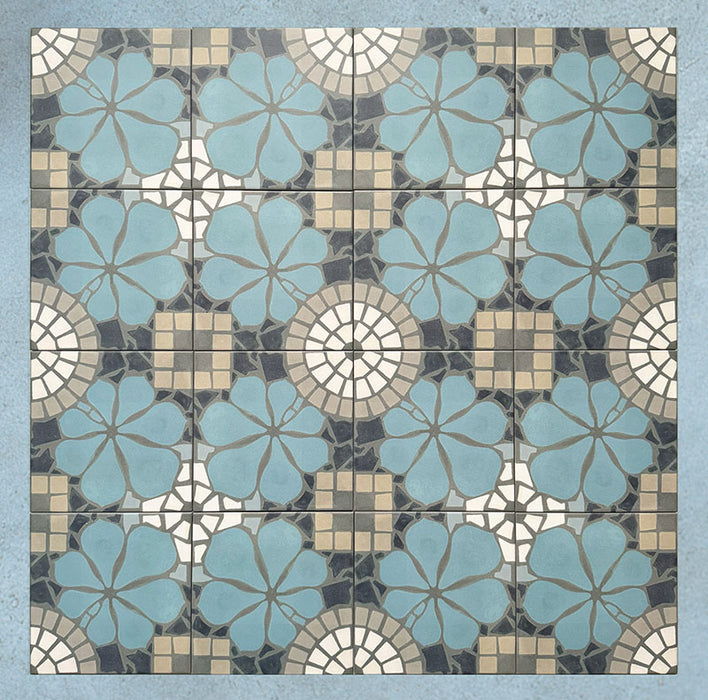 Group of Bloom Azul Blue 20x20cm Moroccan-style ceramic tiles arranged together, showcasing a repeating floral pattern in blue, grey, beige, and white tones on a soft blue background.