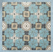 Group of Bloom Azul Blue 20x20cm Moroccan-style ceramic tiles arranged together, showcasing a repeating floral pattern in blue, grey, beige, and white tones on a soft blue background.