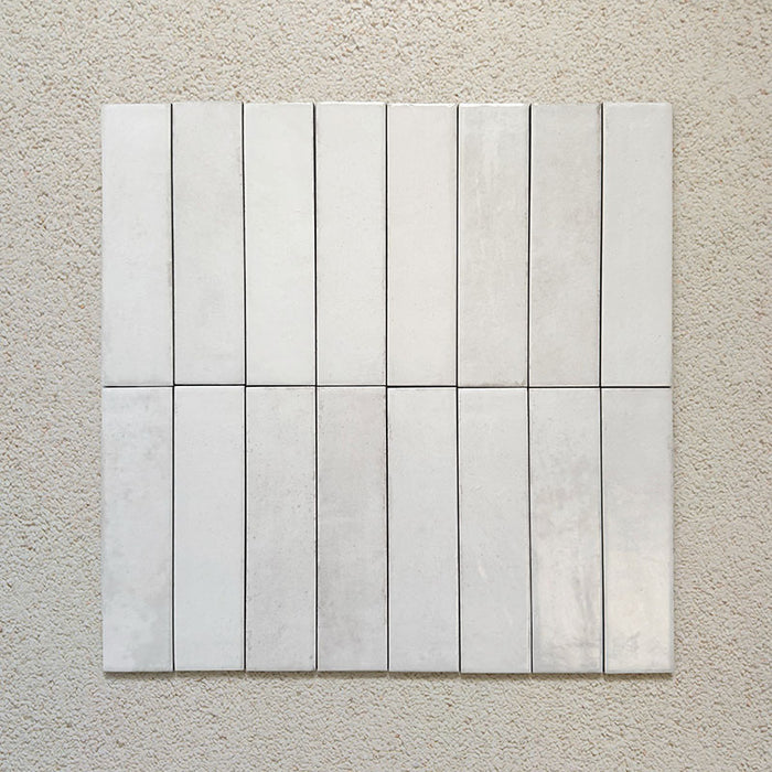 Madison White Brick Wall Tiles 6x24.6cm — group of tiles showcasing their handcrafted surface and subtle tonal variations. The soft white glaze and elongated shape create a refined, artisanal finish ideal for timeless wall designs.