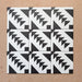 Alhambra Alkazar 20x20cm Moroccan tiles arranged in a group layout, showcasing a bold black and white geometric triangle pattern on a warm terracotta background.