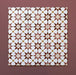 Close-up of multiple Agraba Cotto 20x20cm Moroccan-style ceramic tiles arranged in a grid, showing a geometric star pattern in terracotta, beige, mustard, and white tones on a warm burgundy background.