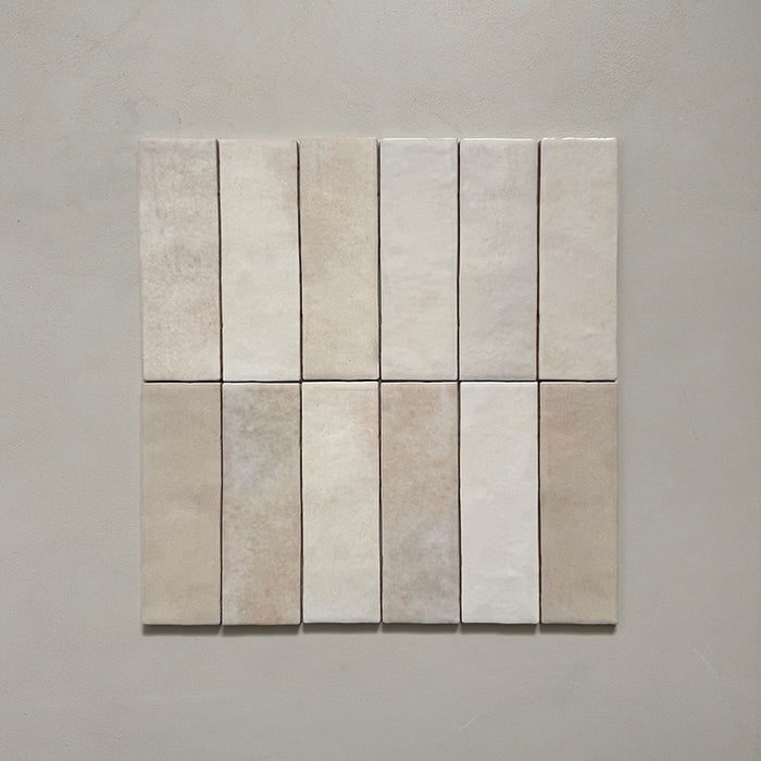Zellij Bone Brick Moroccan-style tiles in a 6.5cm x 20cm brick format, arranged as a grouped layout to showcase the soft warm beige tones and natural handmade surface variation on a neutral background.