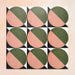Group image showing nine Geometry Moon 20x20cm geometric patterned tiles arranged in a grid, featuring green and terracotta semicircles with black and cream corner details, photographed against a soft peach-toned background.