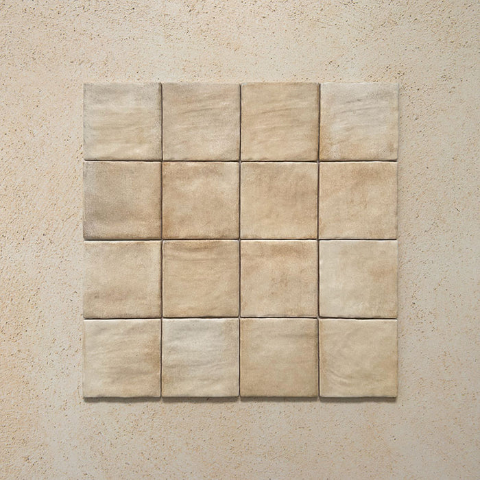 Zellij Arena Square Moroccan Style 10cm x 10cm group of tiles, square Moroccan tiles arranged in a neat grid, warm sandy beige and soft stone tones with subtle tonal variation, gently rippled glossy glazed finish, handcrafted Moroccan-inspired design suitable for walls and splashbacks.