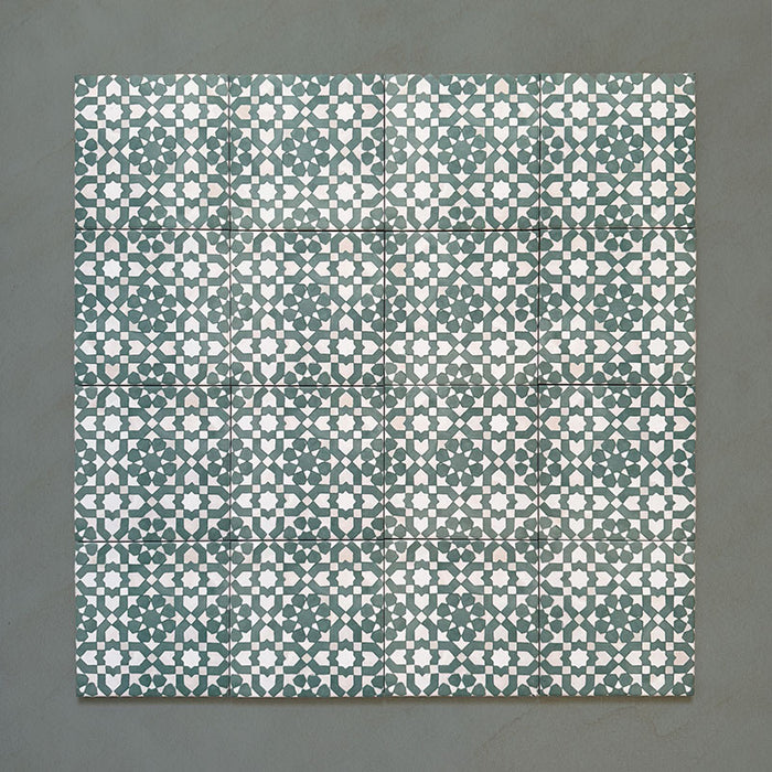 Bedouin Tetuan Green Moroccan-style 15x15cm group of tiles arranged in a grid, displaying an intricate star and cross pattern in rich green, beige, and white shades with a handcrafted matte finish for an authentic artisanal look.