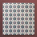 Close-up of multiple Agraba Mini Atlas 15x15cm Moroccan-style ceramic tiles arranged in a grid, showcasing a colourful geometric star pattern in blue, terracotta, black, and white on a warm burgundy background.