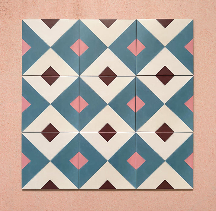 Cabana Guazzatto 20x20cm Moroccan-style porcelain tiles arranged in a group, displaying a repeating geometric diamond pattern in blue, cream, pink, and burgundy hues with a smooth matt finish.
