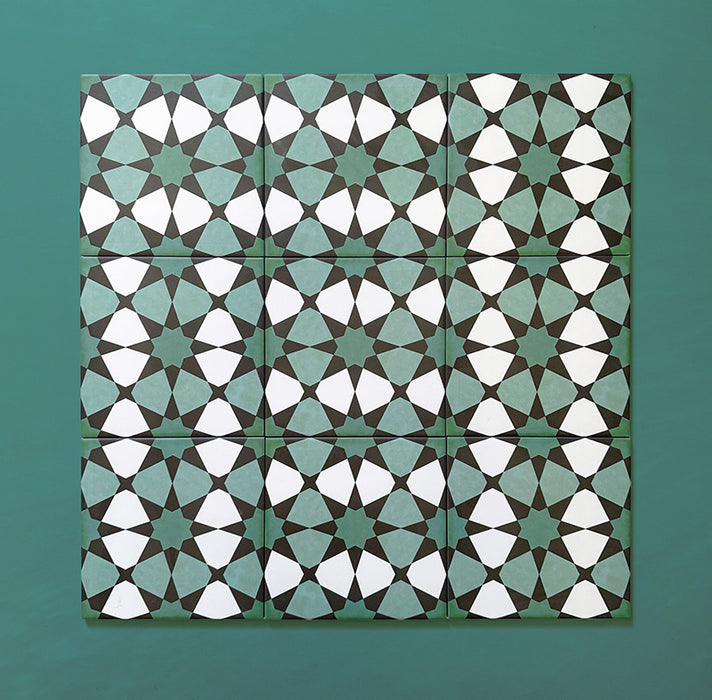 Group of Agraba Verde 20x20cm Moroccan-style ceramic tiles featuring a geometric star pattern in green, mint, and white tones, arranged on a teal background to showcase the intricate repeating design.