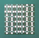 Group of Agraba Verde 20x20cm Moroccan-style ceramic tiles featuring a geometric star pattern in green, mint, and white tones, arranged on a teal background to showcase the intricate repeating design.