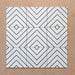 Alhambra Zig Zag Blanco 20x20cm Moroccan tiles shown in a grouped layout, featuring a bold black and white chevron pattern with diamond detailing for a contemporary geometric look.