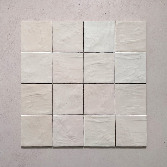 Zellij Pink Mist square Moroccan-style tiles, 13.2cm x 13.2cm, arranged in a full tile group showing soft blush pink tones, subtle colour variation, glossy glazed finish, and gently uneven handcrafted surface texture.