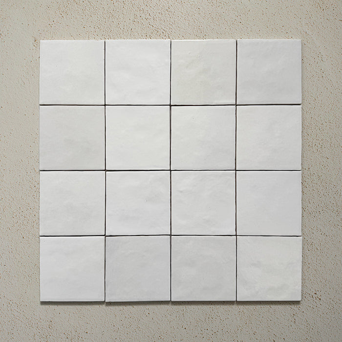Zellij White Gloss Square Moroccan-style tiles in a 13.2cm x 13.2cm format, arranged as a grouped layout to highlight the glossy white glaze and subtle handmade surface variation on a neutral background.