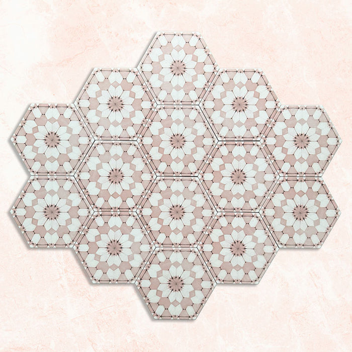 Maroush Dusty Pink 18.7x21.6cm Moroccan hexagonal tiles arranged in a group, displaying a detailed floral star pattern in soft pink and white against a pale marble-effect background.
