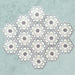 Maroush Frost Blue 18.7x21.6cm Moroccan hexagonal tiles arranged in a group, showcasing a repeating starburst floral pattern in soft blue, white, and grey tones on a textured pale blue background.