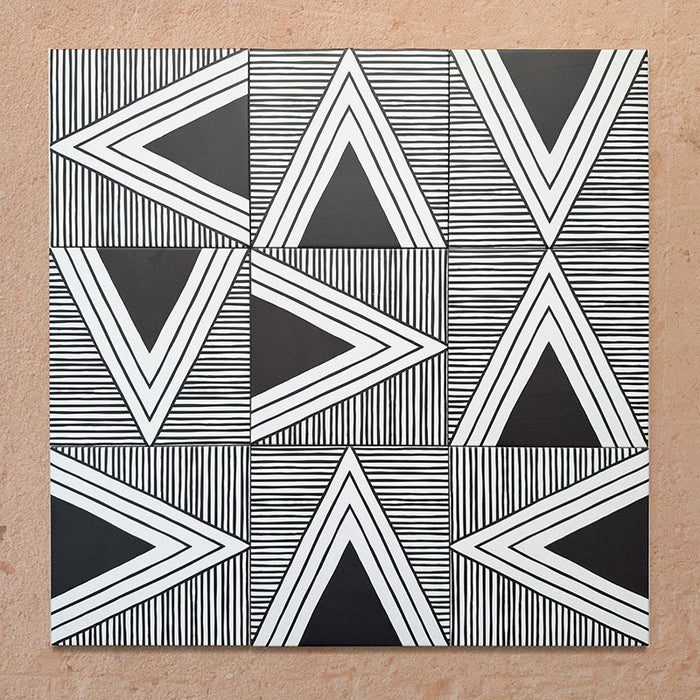 Alhambra Pyramid 20x20cm Moroccan tiles displayed in a bold geometric layout with alternating black and white triangle patterns and fine linear detailing for a striking modern look.