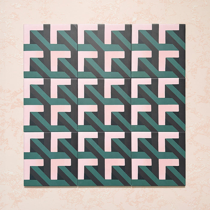 Group display of Geometry Lagoon 20x20cm patterned ceramic tiles arranged in a repeated layout, featuring an interlocking geometric design in blush pink, deep teal, and charcoal tones against a soft textured beige backdrop.